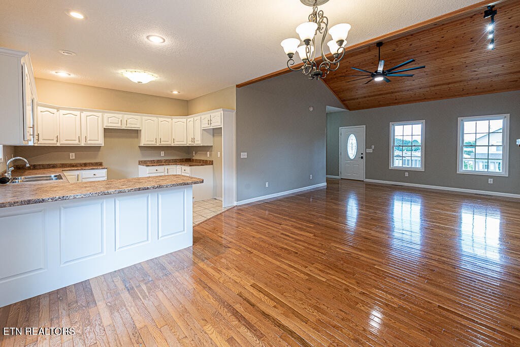 200 West Park Circle Decatur, TN 37322 - Photo 11 of 25 a open kitchen with kitchen island a refrigerator a stove a sink dishwasher and wooden cabinets with wooden floor