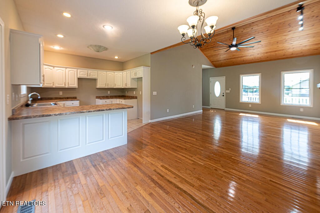 200 West Park Circle Decatur, TN 37322 - Photo 8 of 25 a kitchen with stainless steel appliances granite countertop a refrigerator a sink dishwasher a stove and white countertops with wooden floor