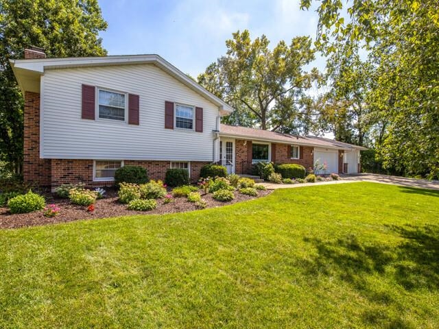 203 Wood Road Rockford, IL 61107 - Photo 1 of 32 a view of a house with swimming pool and garden