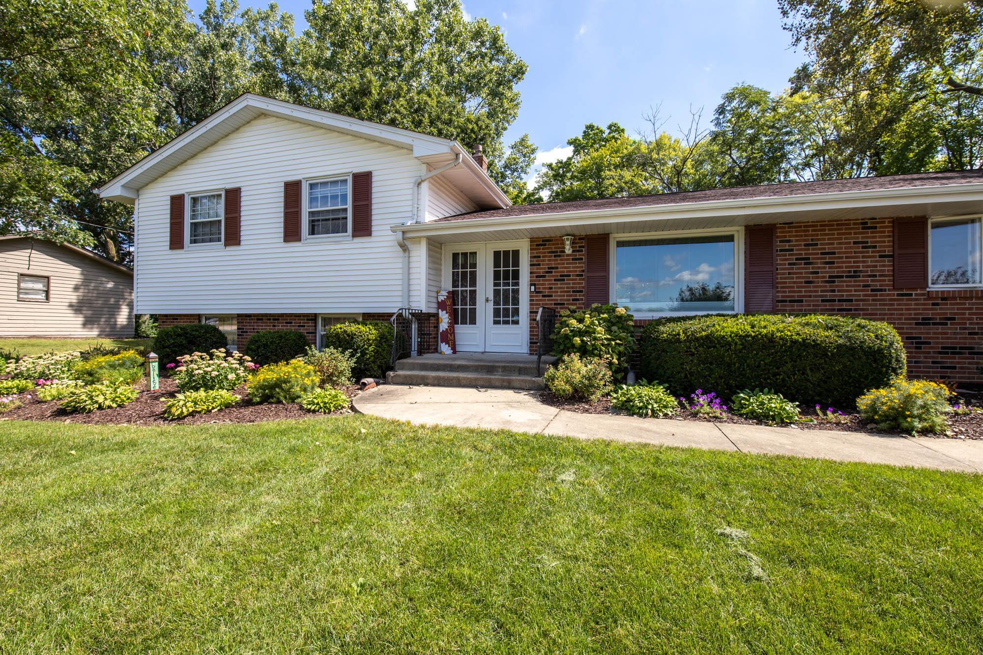 203 Wood Road Rockford, IL 61107 - Photo 3 of 32 a front view of a house with a yard and potted plants