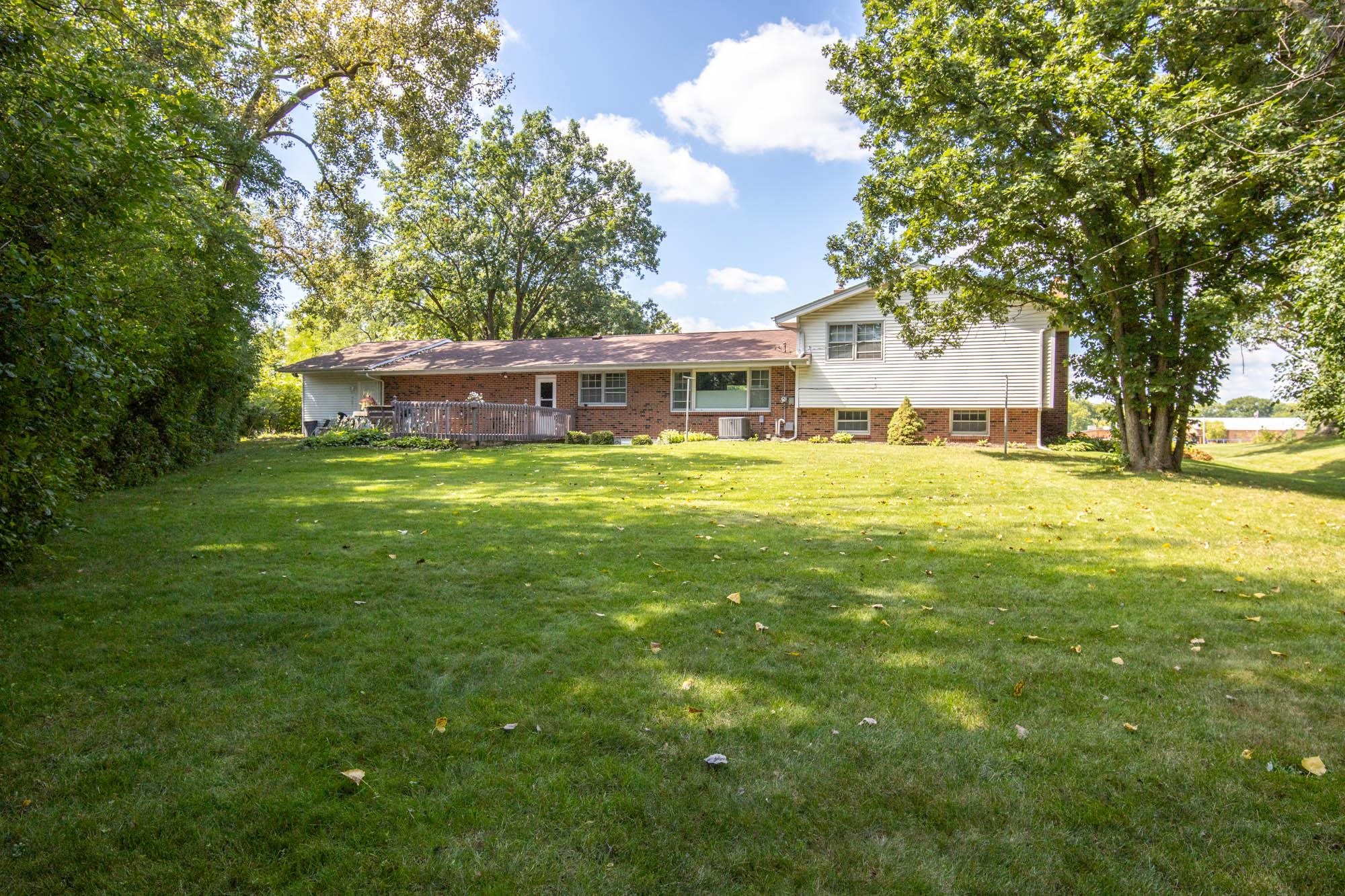 203 Wood Road Rockford, IL 61107 - Photo 31 of 32 a view of a house with a big yard and large trees