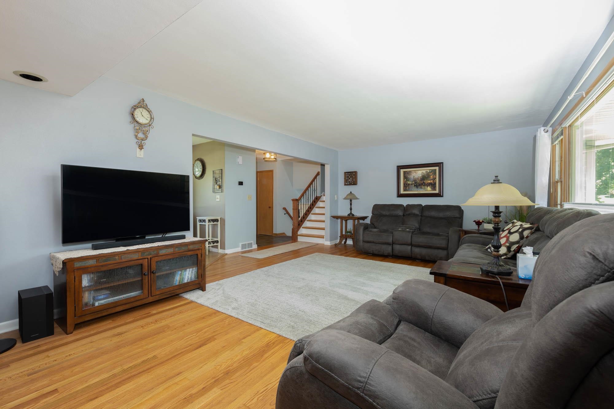 203 Wood Road Rockford, IL 61107 - Photo 5 of 32 a living room with furniture and a flat screen tv