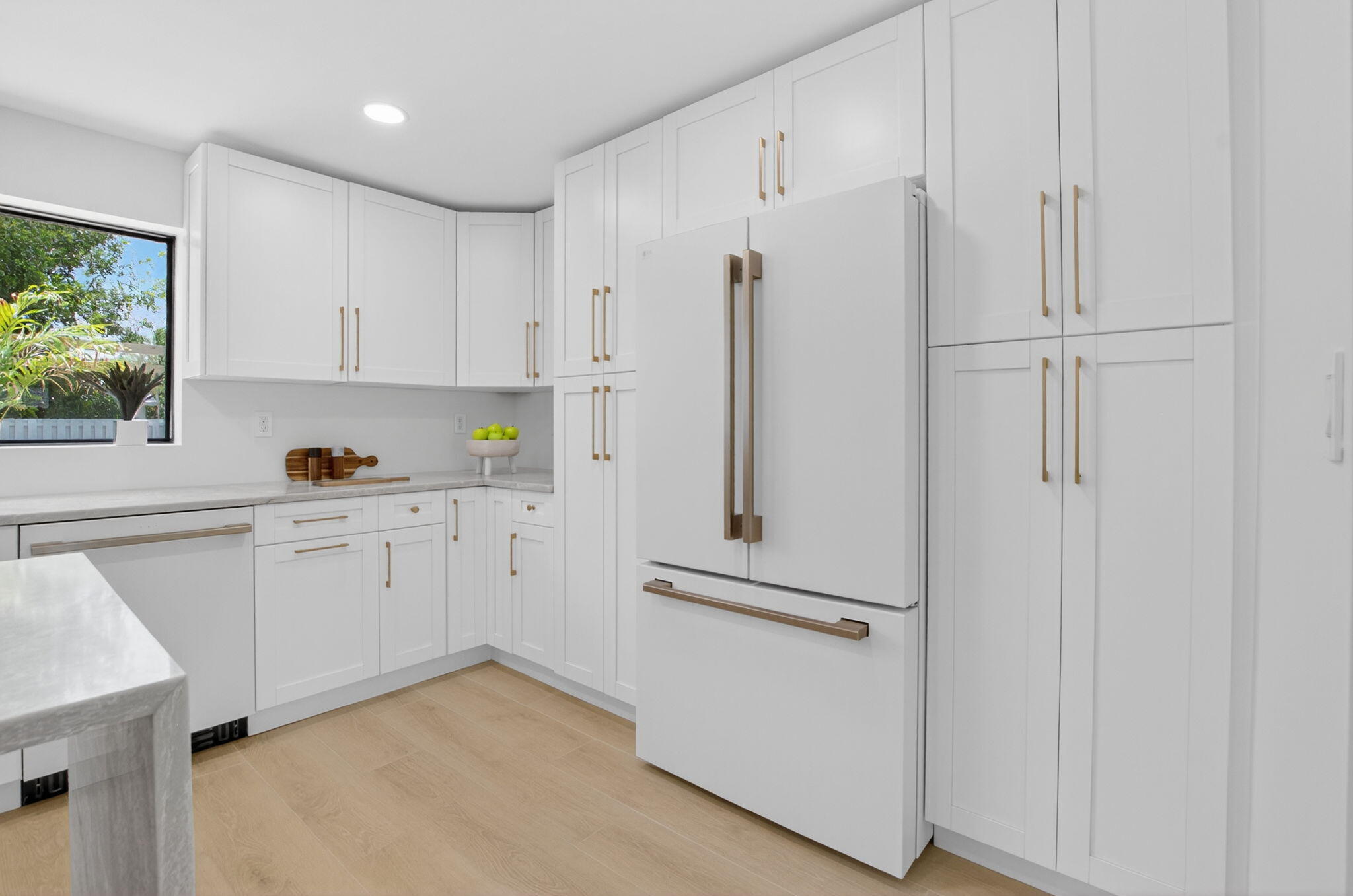 1780 Southwest 9th Street Boca Raton, FL 33486 - Photo 11 of 67 a kitchen with white cabinets and white appliances