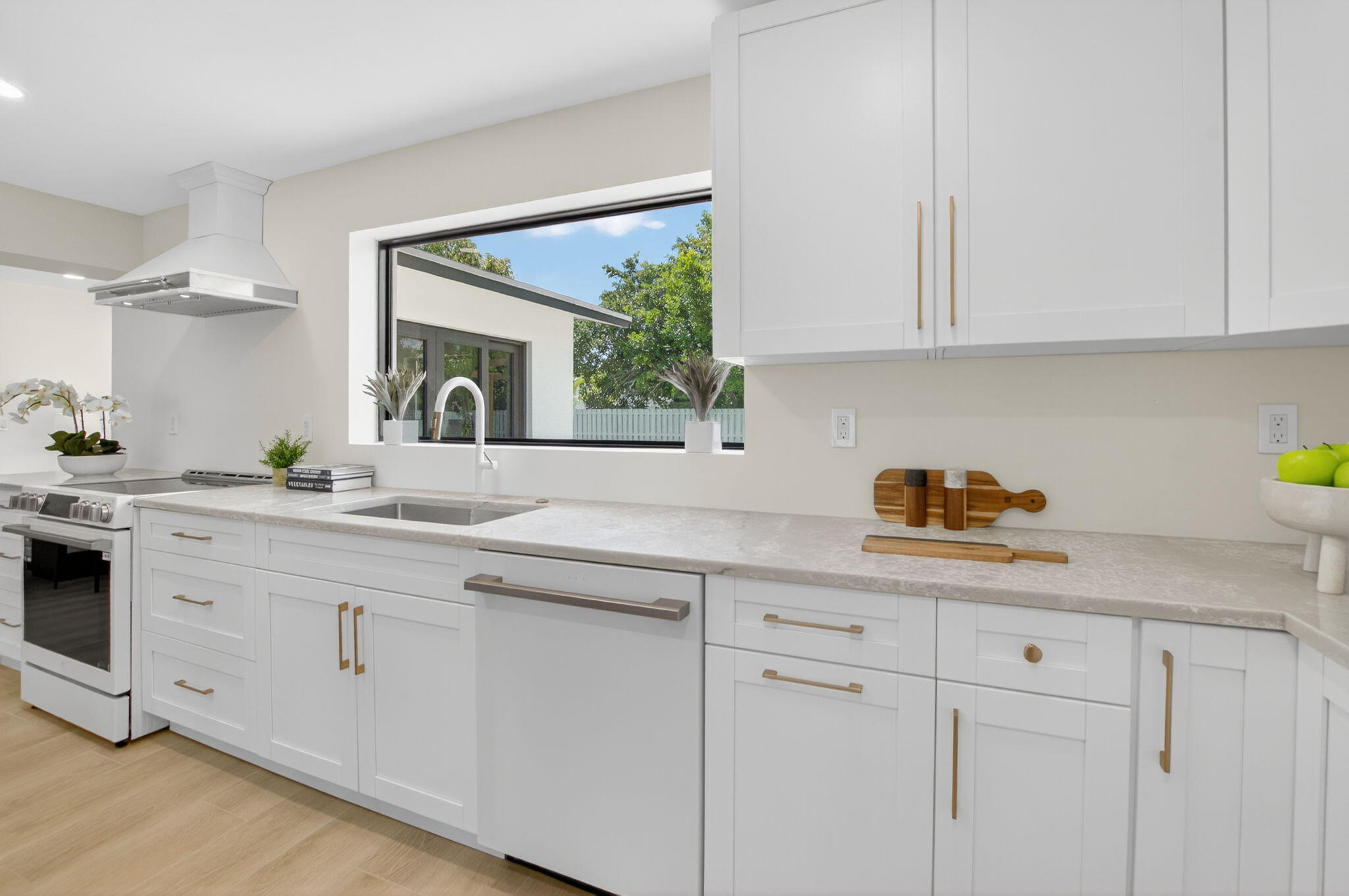 1780 Southwest 9th Street Boca Raton, FL 33486 - Photo 13 of 67 a kitchen with white cabinets and sink