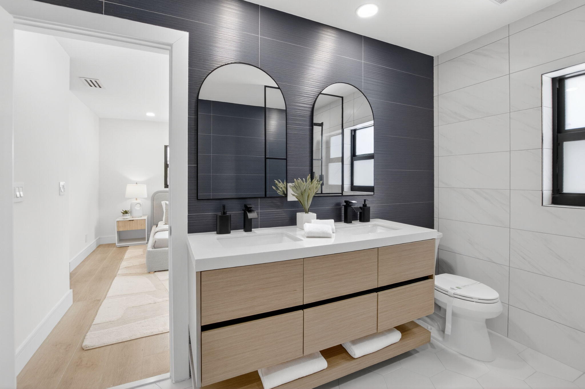 1780 Southwest 9th Street Boca Raton, FL 33486 - Photo 30 of 67 a bathroom with a double vanity sink toilet and a mirror