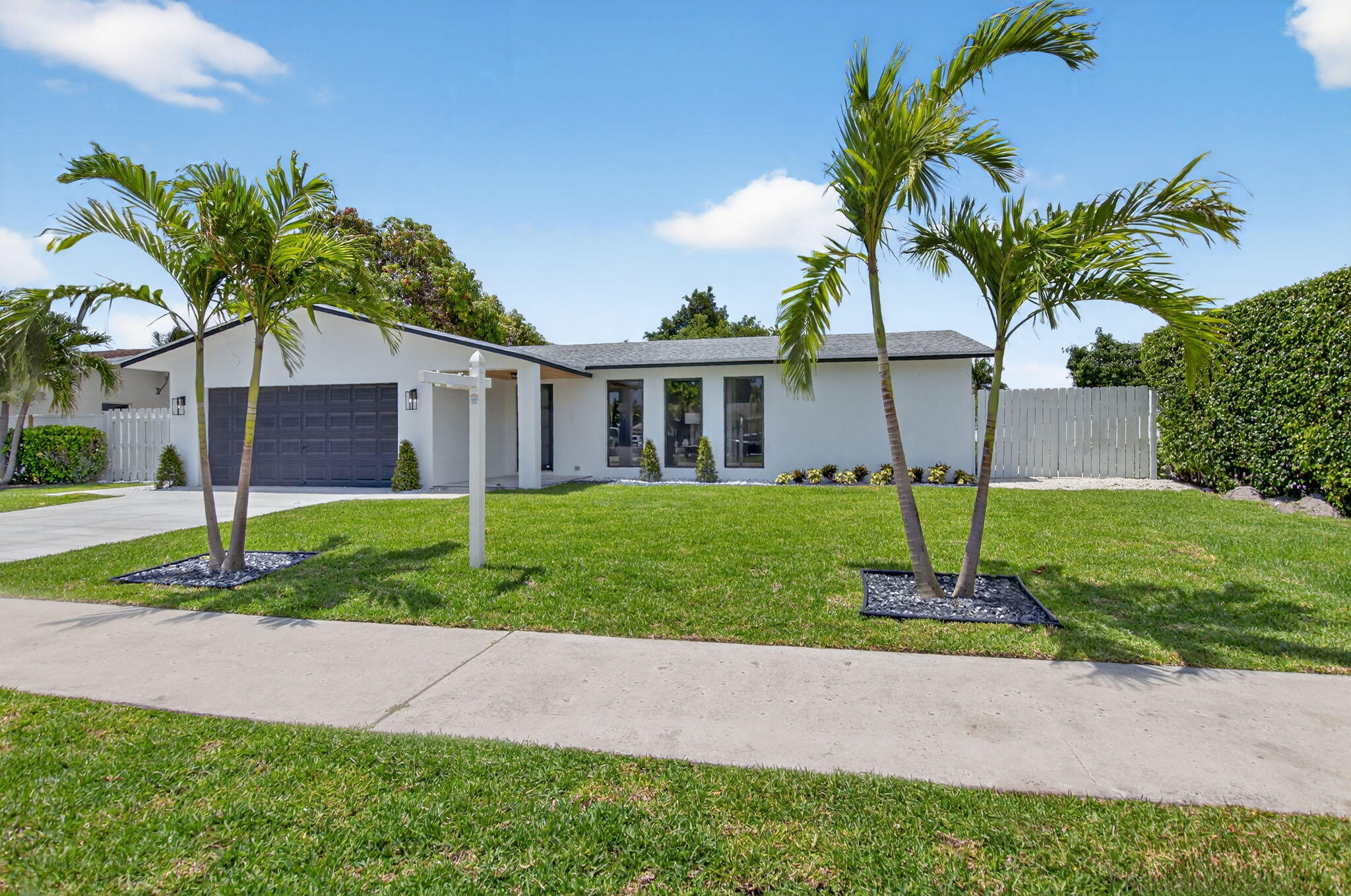 1780 Southwest 9th Street Boca Raton, FL 33486 - Photo 67 of 67 a front view of a house with a yard and garage