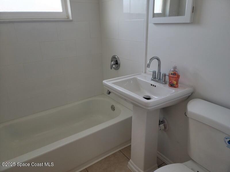 1700 Chaucer Road Titusville, FL 32780 - Photo 12 of 15 a bathroom with a sink and a toilet