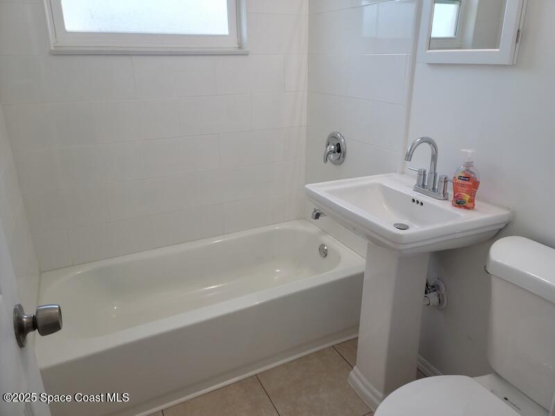 1700 Chaucer Road Titusville, FL 32780 - Photo 13 of 15 a bathroom with a sink a toilet and shower