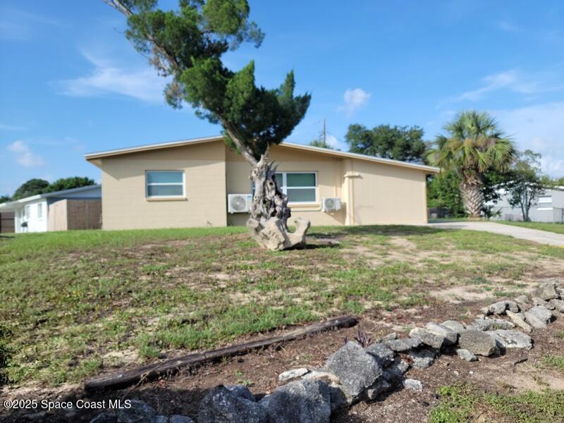 1700 Chaucer Road Titusville, FL 32780 - Photo 2 of 15 a front view of house with yard and trees around
