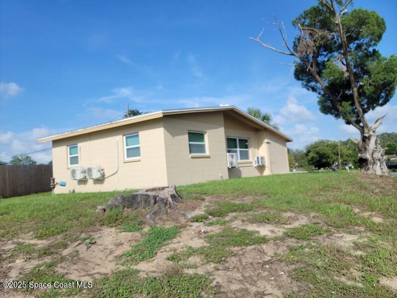 1700 Chaucer Road Titusville, FL 32780 - Photo 4 of 15 a view of a house with backyard and garden