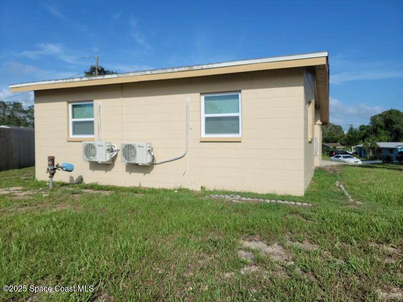 1700 Chaucer Road Titusville, FL 32780 - Photo 5 of 15 a backyard of a house with table and chairs