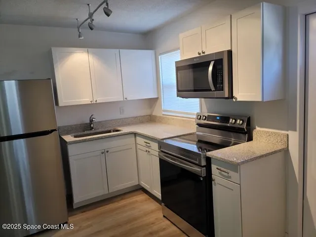 a kitchen with a sink and a stove top oven