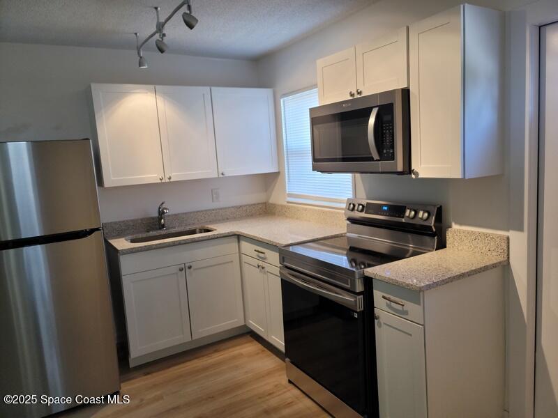 1700 Chaucer Road Titusville, FL 32780 - Photo 7 of 15 a kitchen with a sink and a stove top oven