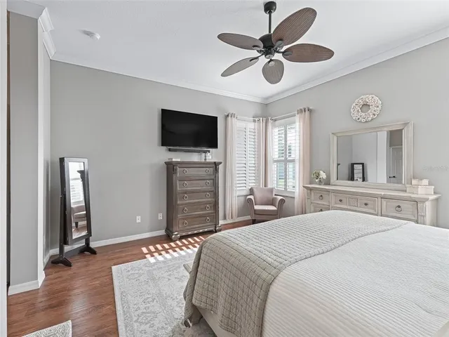 a spacious bathroom with a granite countertop double vanity sink a mirror and a bathtub