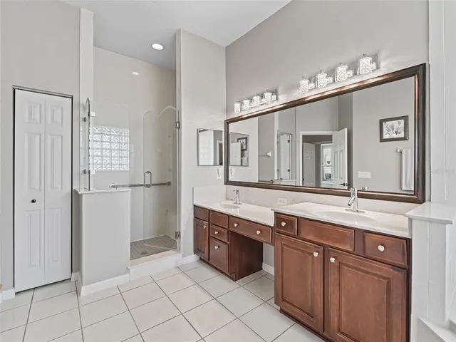 a bathroom with a granite countertop sink mirror and double