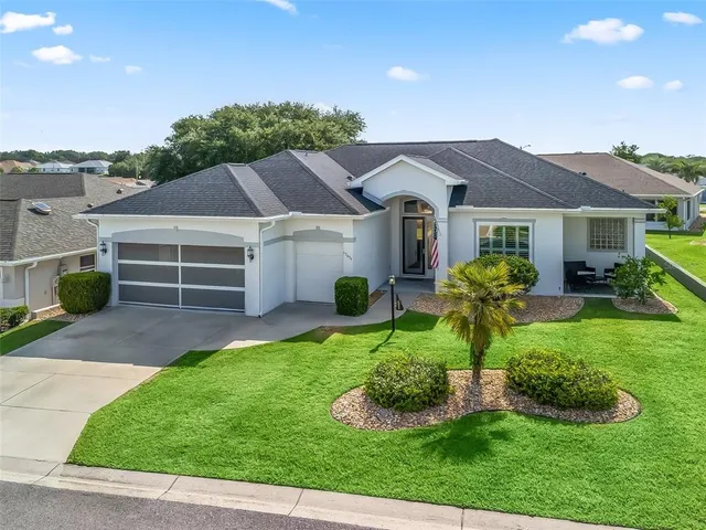 a front view of a house with a yard and garage