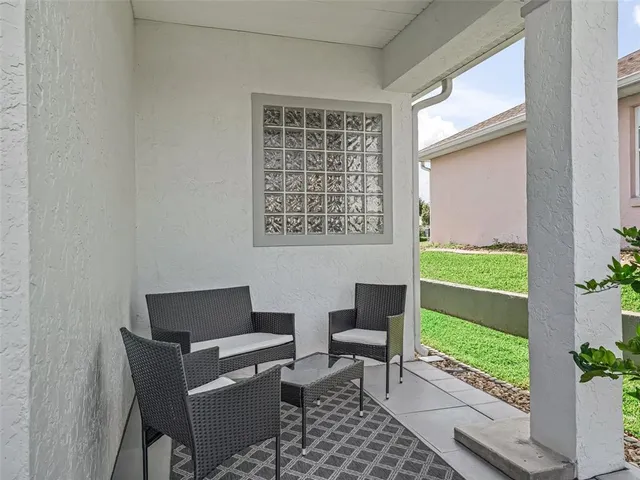 a view of a patio with table and chairs with wooden floor and plants