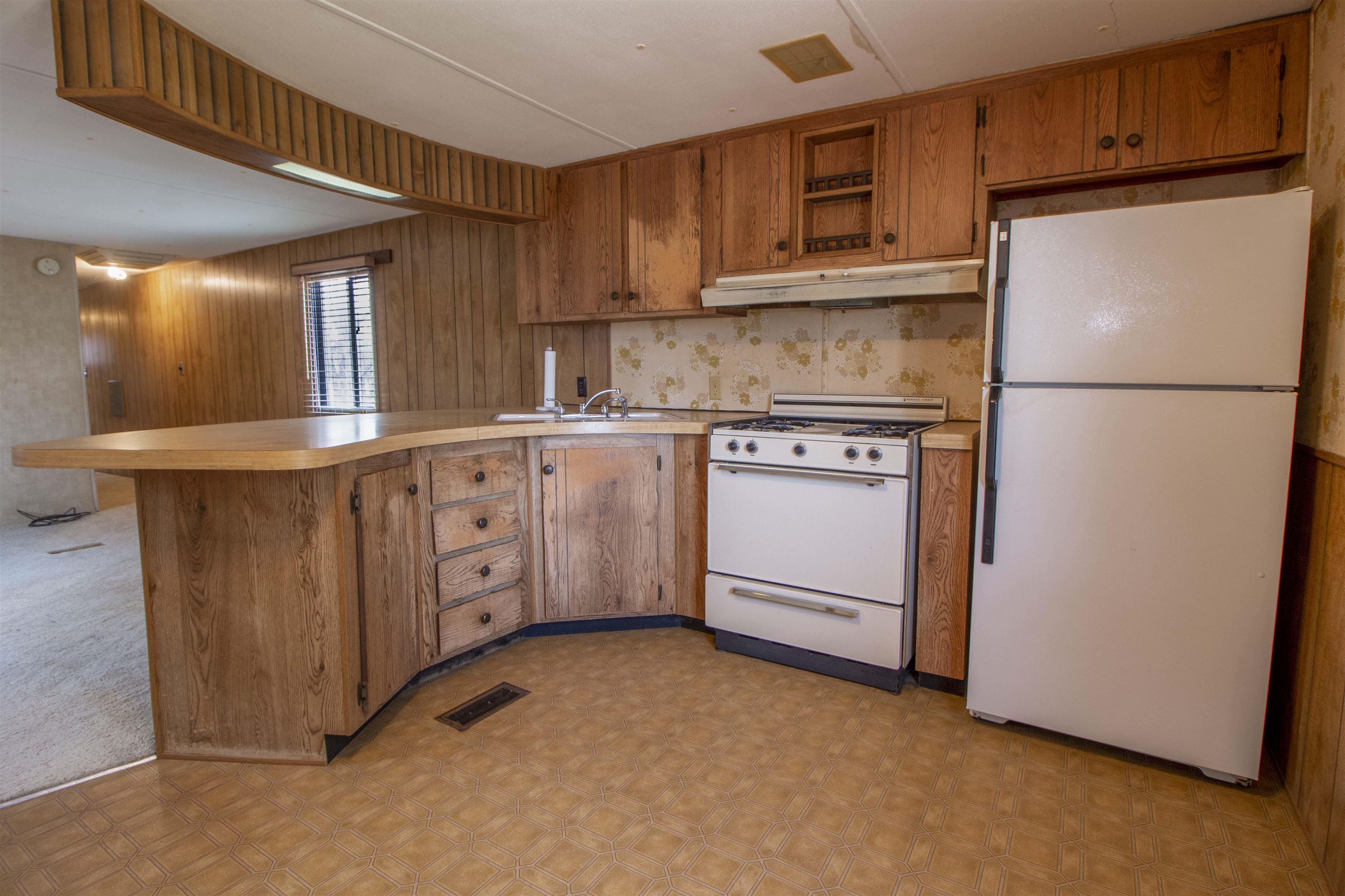 808 24 Road Grand Junction, CO 81505 - Photo 13 of 23 a kitchen with stainless steel appliances granite countertop a refrigerator a stove a sink and a microwave