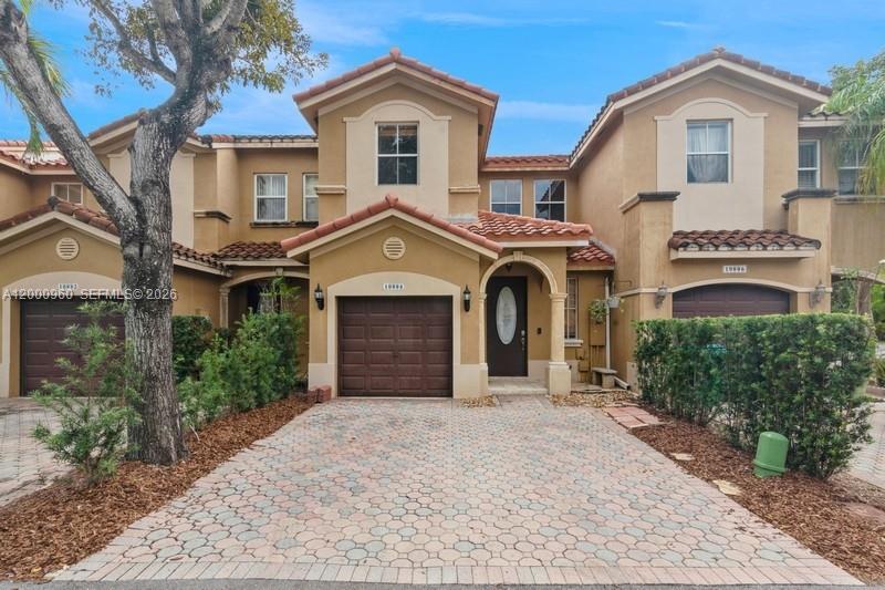 10884 Southwest 89th Street Miami, FL 33176 - Photo 1 of 10 a front view of a house with a yard and garage
