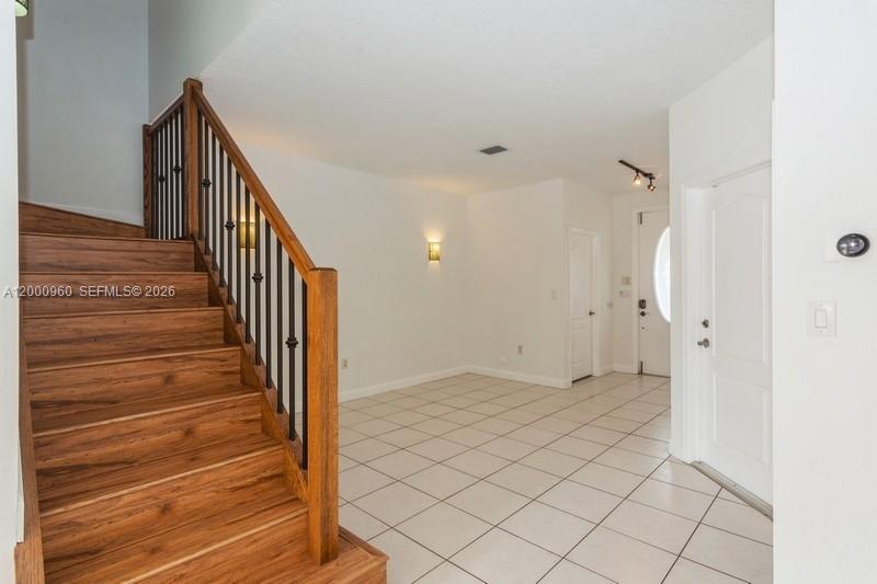 10884 Southwest 89th Street Miami, FL 33176 - Photo 2 of 10 a view of a hallway with wooden floor and staircase