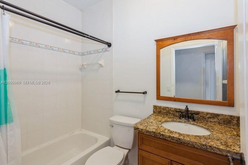 10884 Southwest 89th Street Miami, FL 33176 - Photo 6 of 10 a bathroom with a granite countertop sink toilet and shower