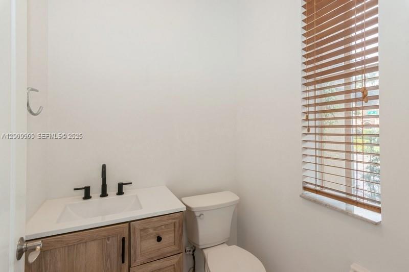 10884 Southwest 89th Street Miami, FL 33176 - Photo 8 of 10 a bathroom with a sink and a toilet