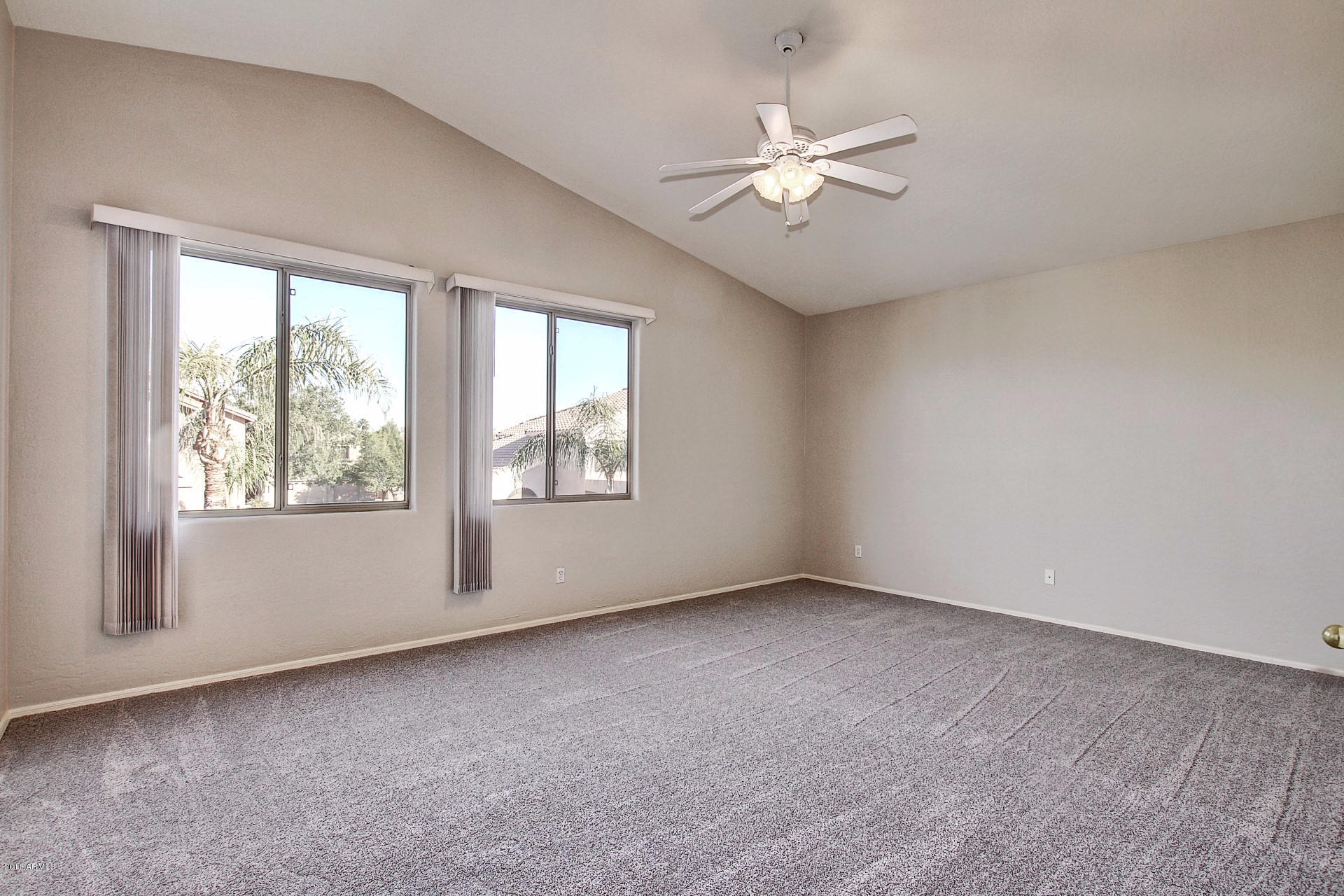 1360 East Harrison Street Gilbert, AZ 85295 - Photo 18 of 34 an empty room with windows and fan