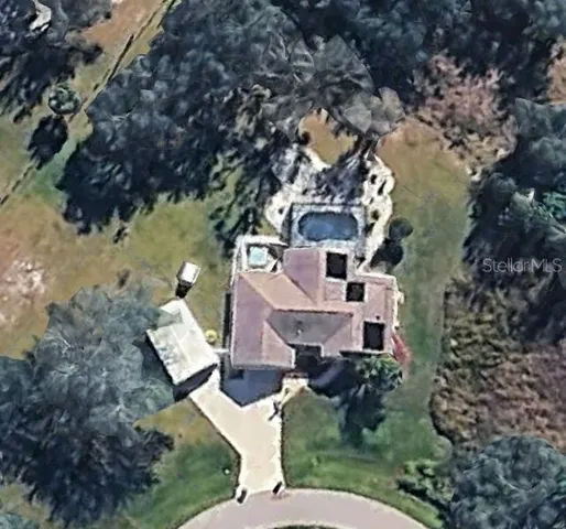 a aerial view of a house with a yard
