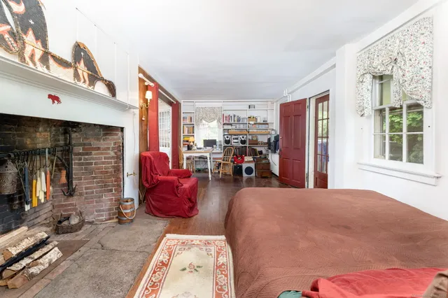 a bedroom with furniture and a window
