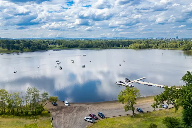 an aerial view of a house with a yard and lake view
