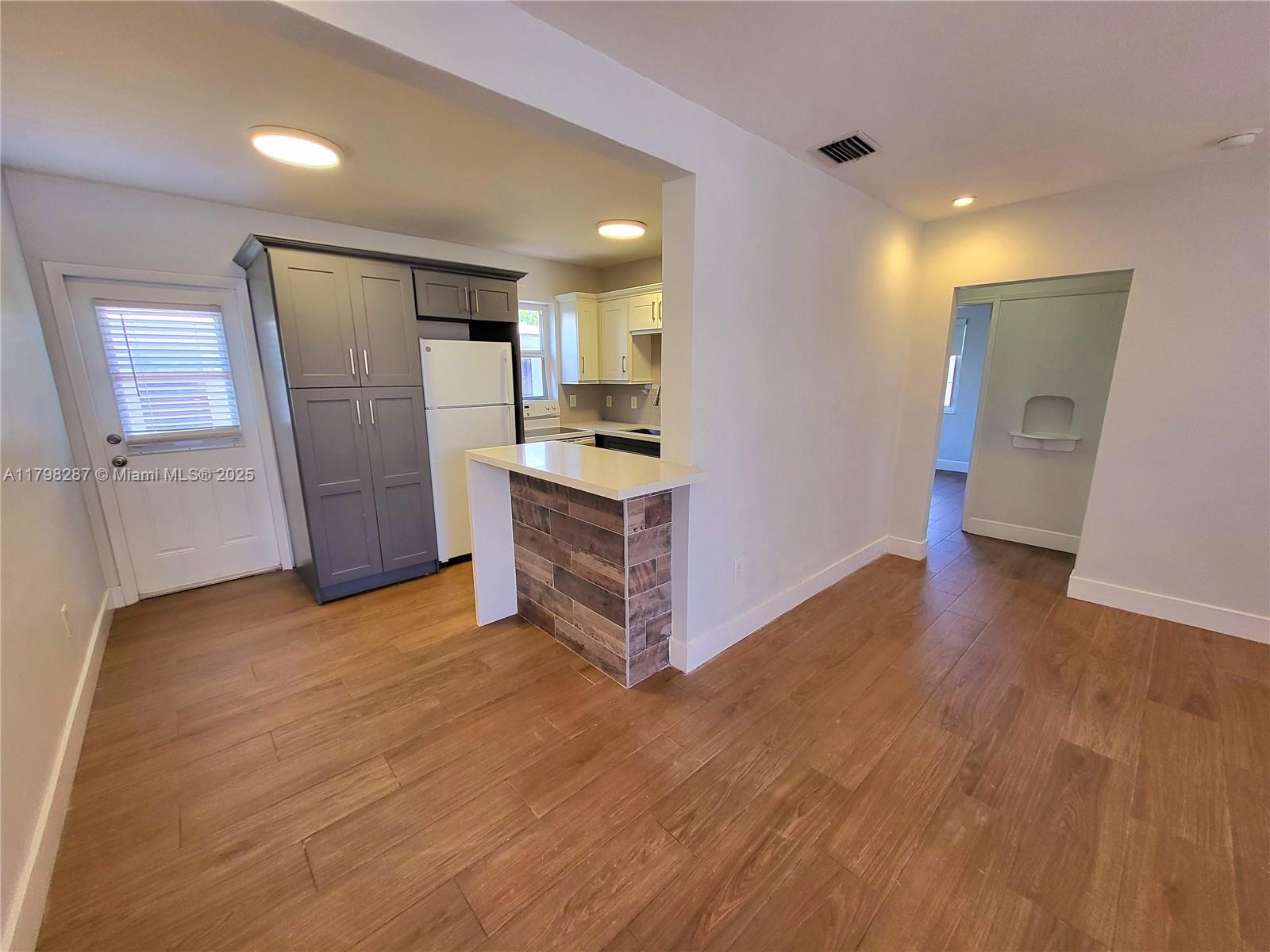 2355 Southwest 27th Street, Unit 4 Miami, FL 33133 - Photo 16 of 25 a view of a kitchen with a sink and a refrigerator