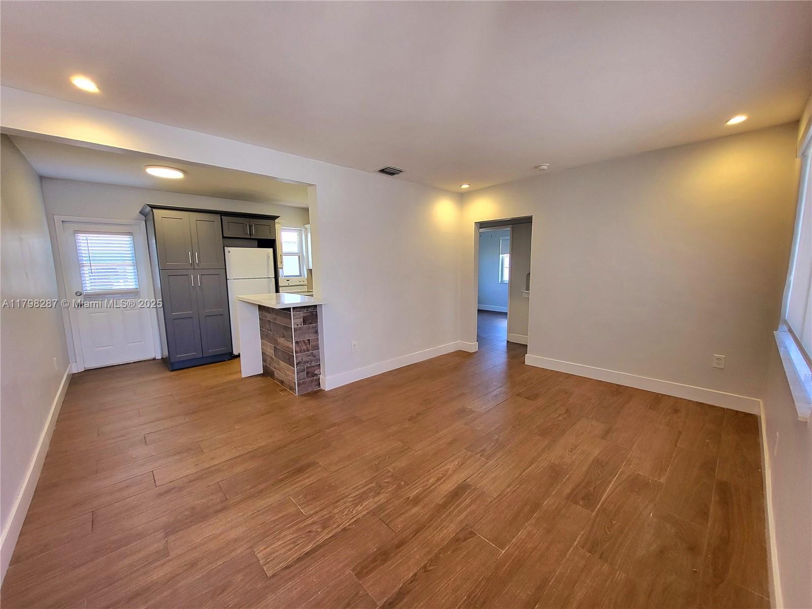 2355 Southwest 27th Street, Unit 4 Miami, FL 33133 - Photo 23 of 25 a view of empty room with wooden floor