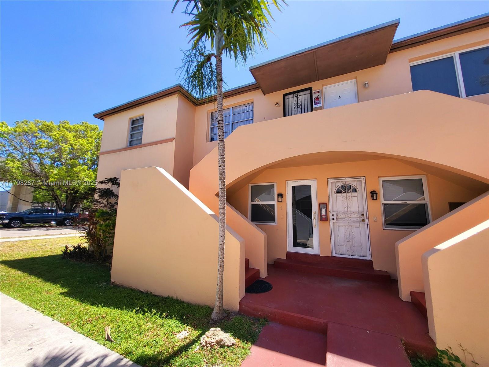 2355 Southwest 27th Street, Unit 4 Miami, FL 33133 - Photo 24 of 25 a view of a house with a yard and garage