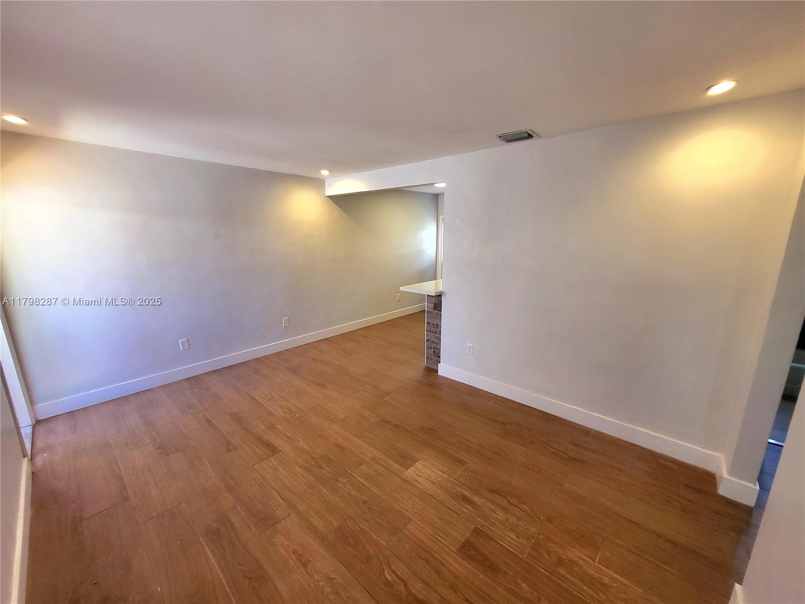 2355 Southwest 27th Street, Unit 4 Miami, FL 33133 - Photo 5 of 25 a view of empty room with wooden floor