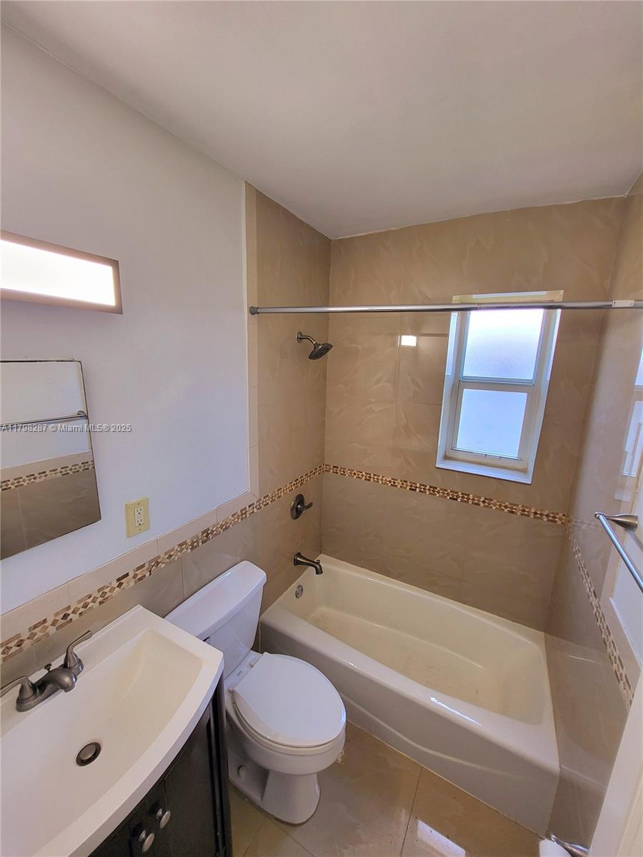 2355 Southwest 27th Street, Unit 4 Miami, FL 33133 - Photo 6 of 25 a bathroom with a sink mirror toilet and bathtub