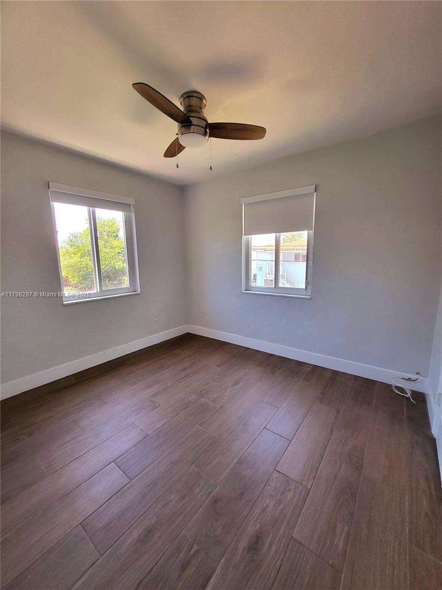 2355 Southwest 27th Street, Unit 4 Miami, FL 33133 - Photo 8 of 25 wooden floor in an empty room with a window