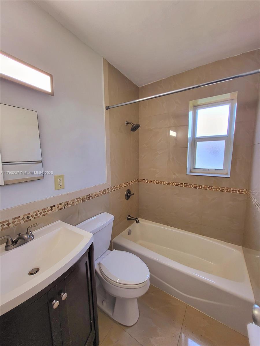 2355 Southwest 27th Street, Unit 4 Miami, FL 33133 - Photo 9 of 25 a bathroom with a sink a toilet and shower