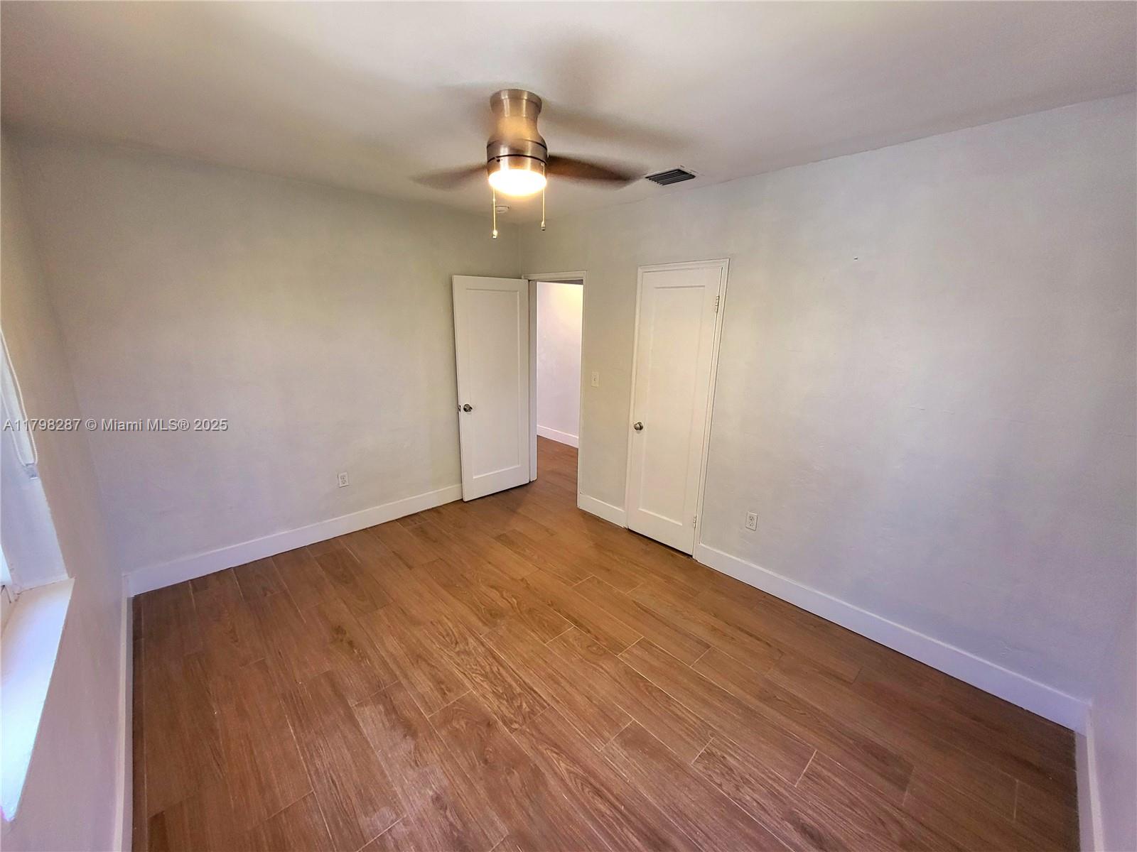 2355 Southwest 27th Street, Unit 4 Miami, FL 33133 - Photo 10 of 25 wooden floor in an empty room with a window