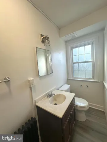 a bathroom with a sink toilet and mirror