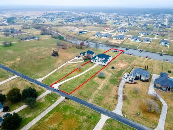 an aerial view of a pool a yard and mountain view