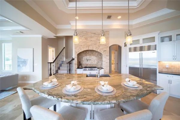 a dining room with furniture a chandelier and wooden floor