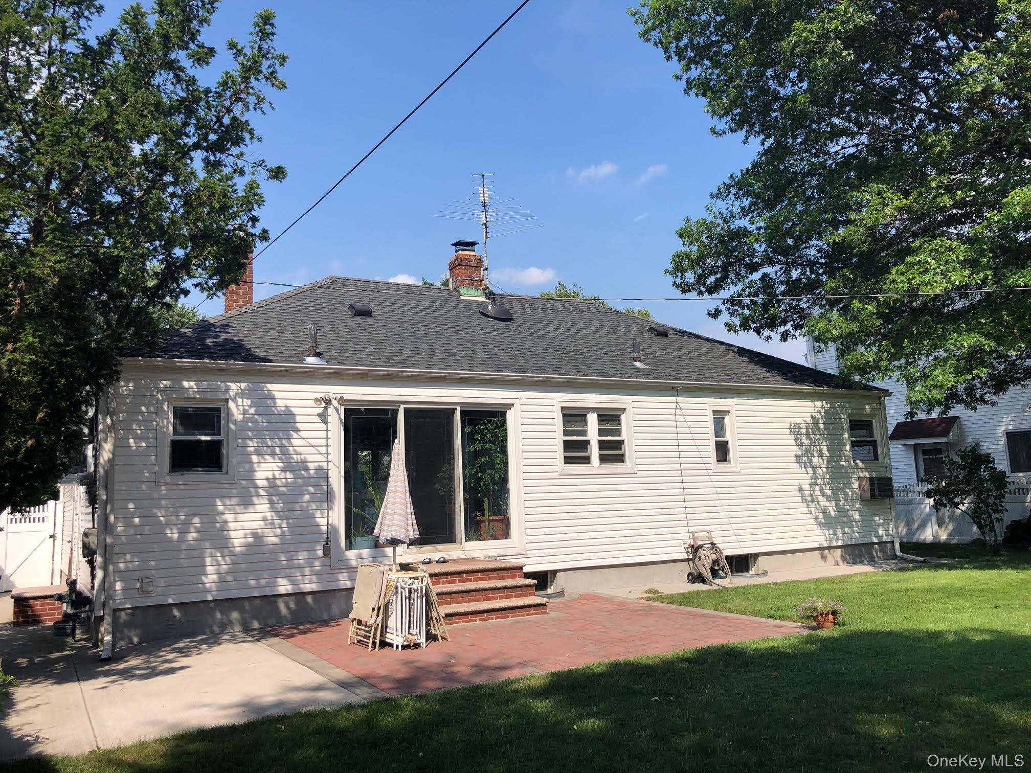 69 Soundview Road Great Neck, NY 11020 - Photo 8 of 8 a front view of a house with a yard