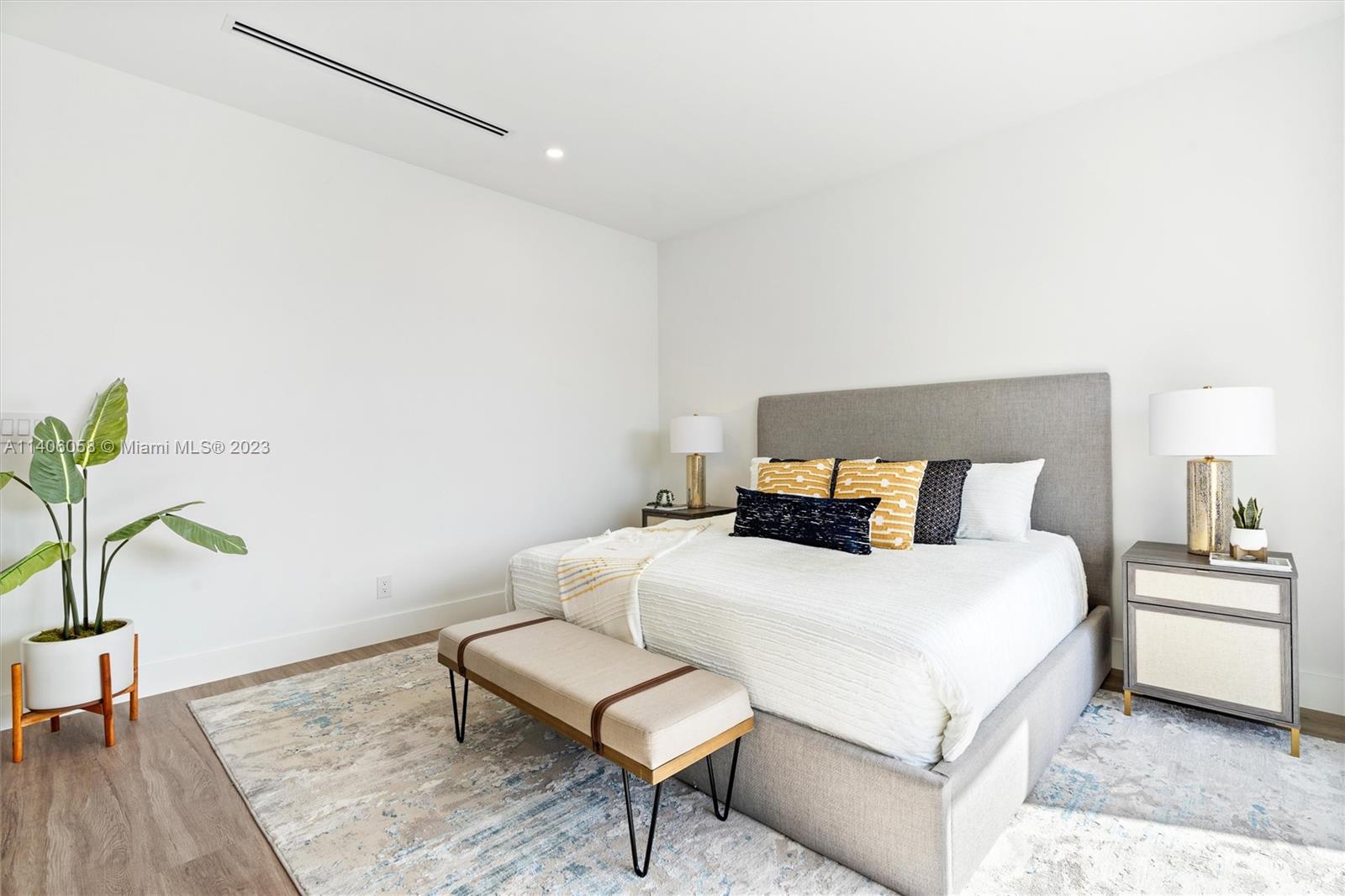 2290 Southeast 6th Street Pompano Beach, FL 33062 - Photo 16 of 22 a bedroom with a bed and a potted plant