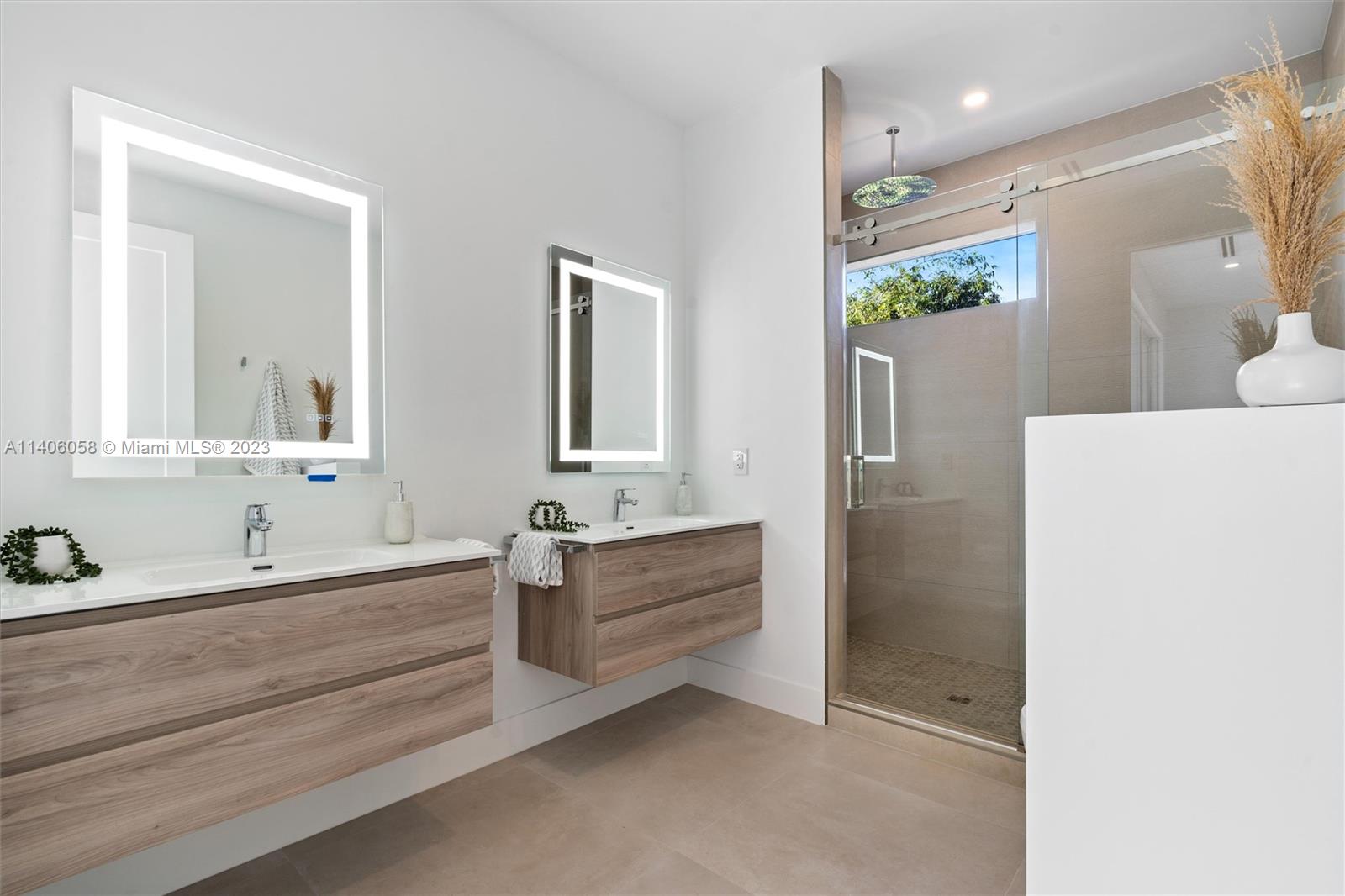 2290 Southeast 6th Street Pompano Beach, FL 33062 - Photo 17 of 22 a bathroom with a bathtub sink and mirror