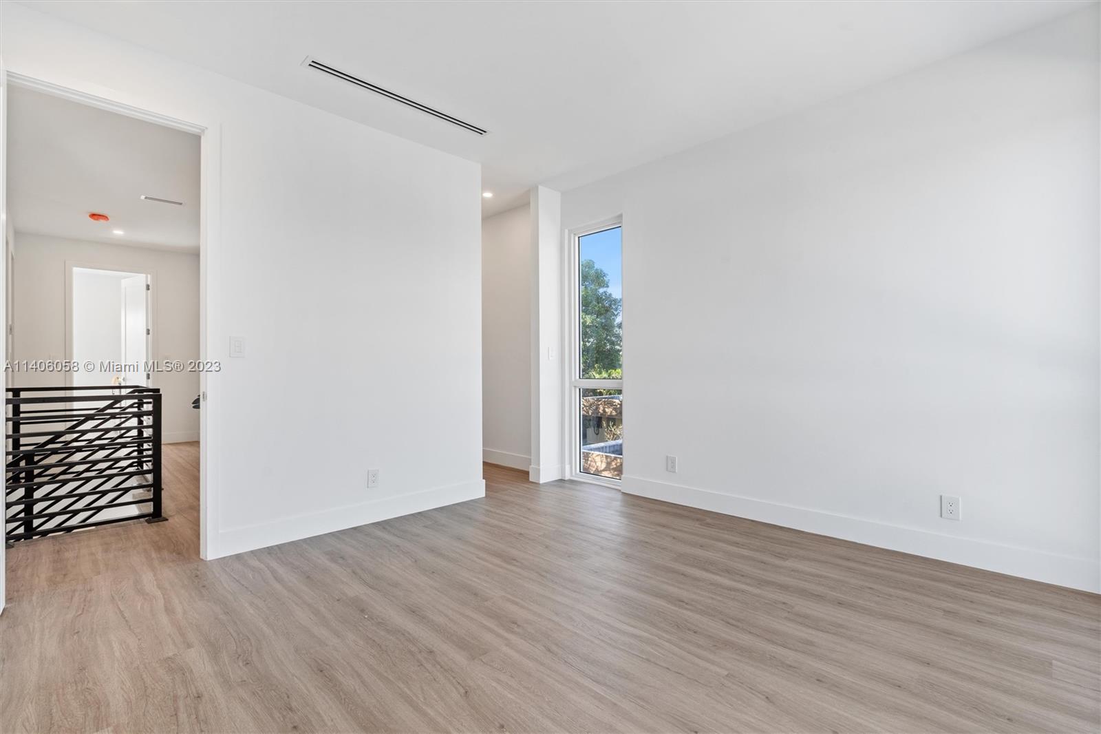 2290 Southeast 6th Street Pompano Beach, FL 33062 - Photo 19 of 22 an empty room with wooden floor and windows