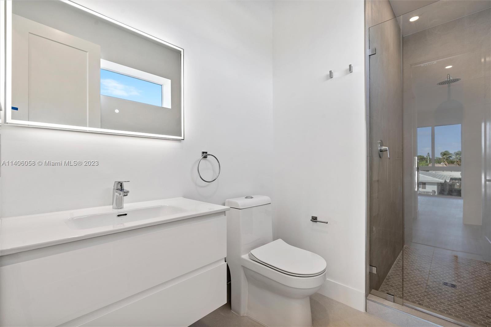 2290 Southeast 6th Street Pompano Beach, FL 33062 - Photo 20 of 22 a bathroom with a sink a toilet and shower