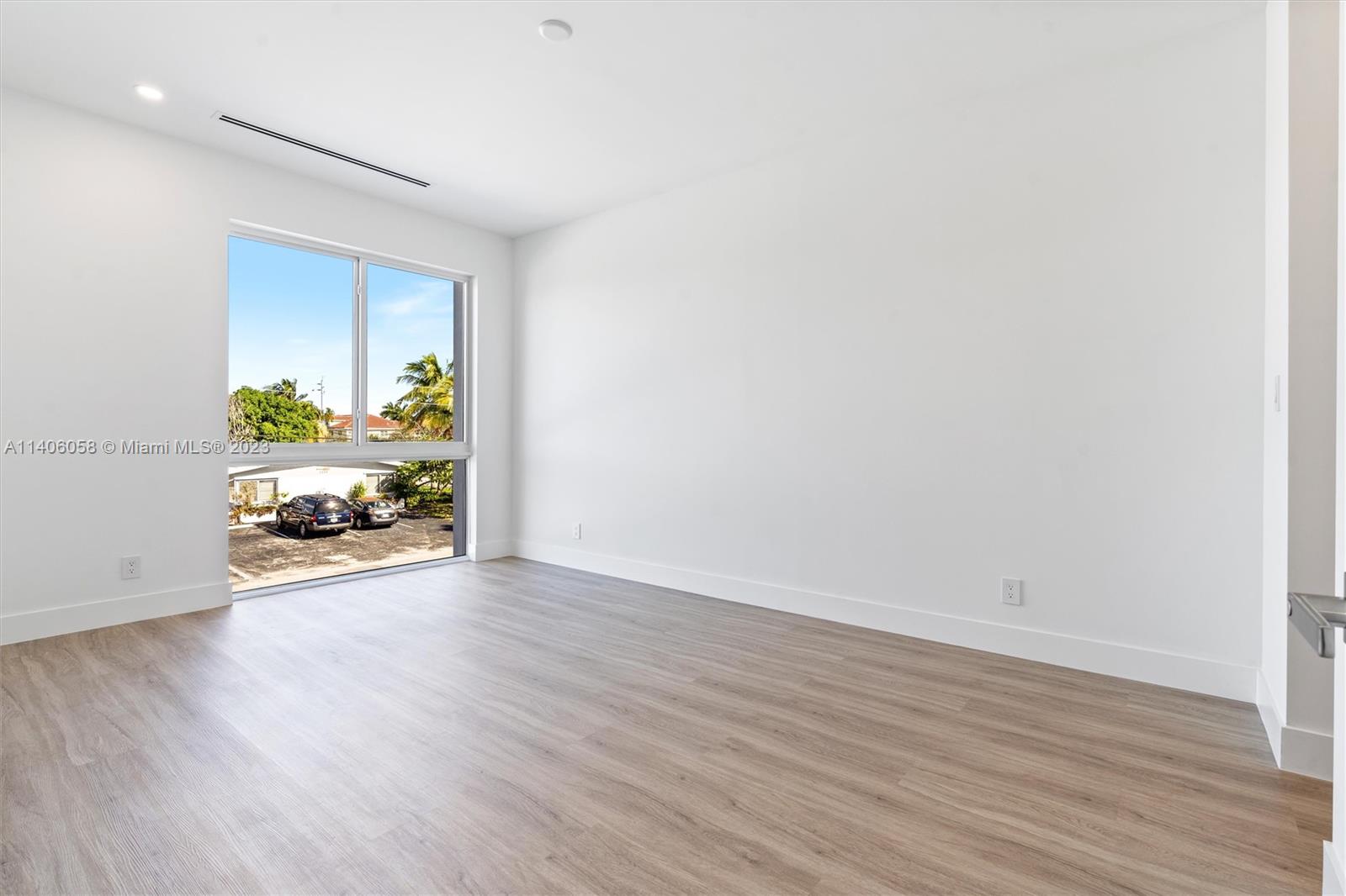 2290 Southeast 6th Street Pompano Beach, FL 33062 - Photo 21 of 22 a view of an empty room with window and wooden floor