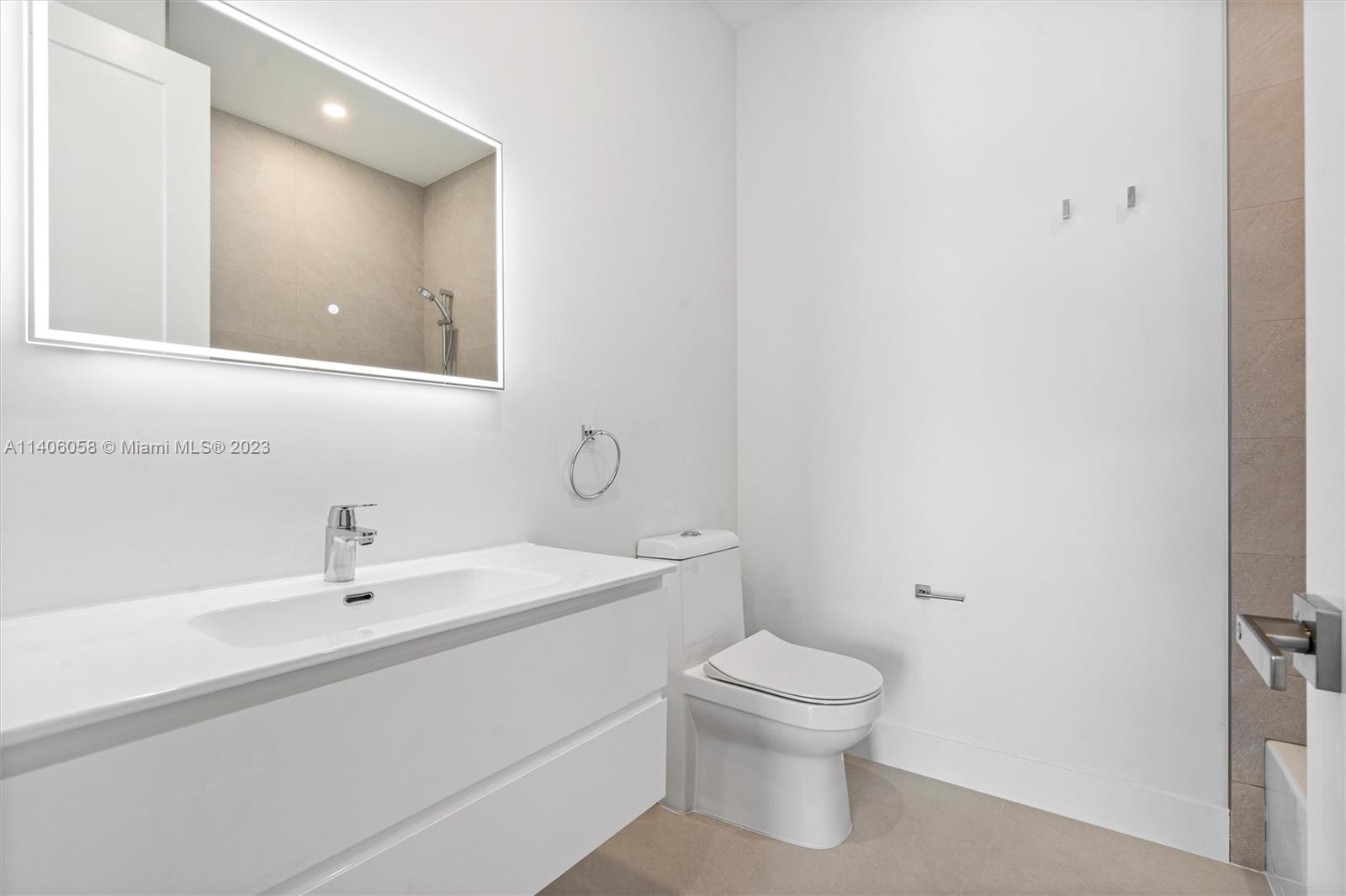 2290 Southeast 6th Street Pompano Beach, FL 33062 - Photo 22 of 22 a bathroom with a toilet a sink and mirror