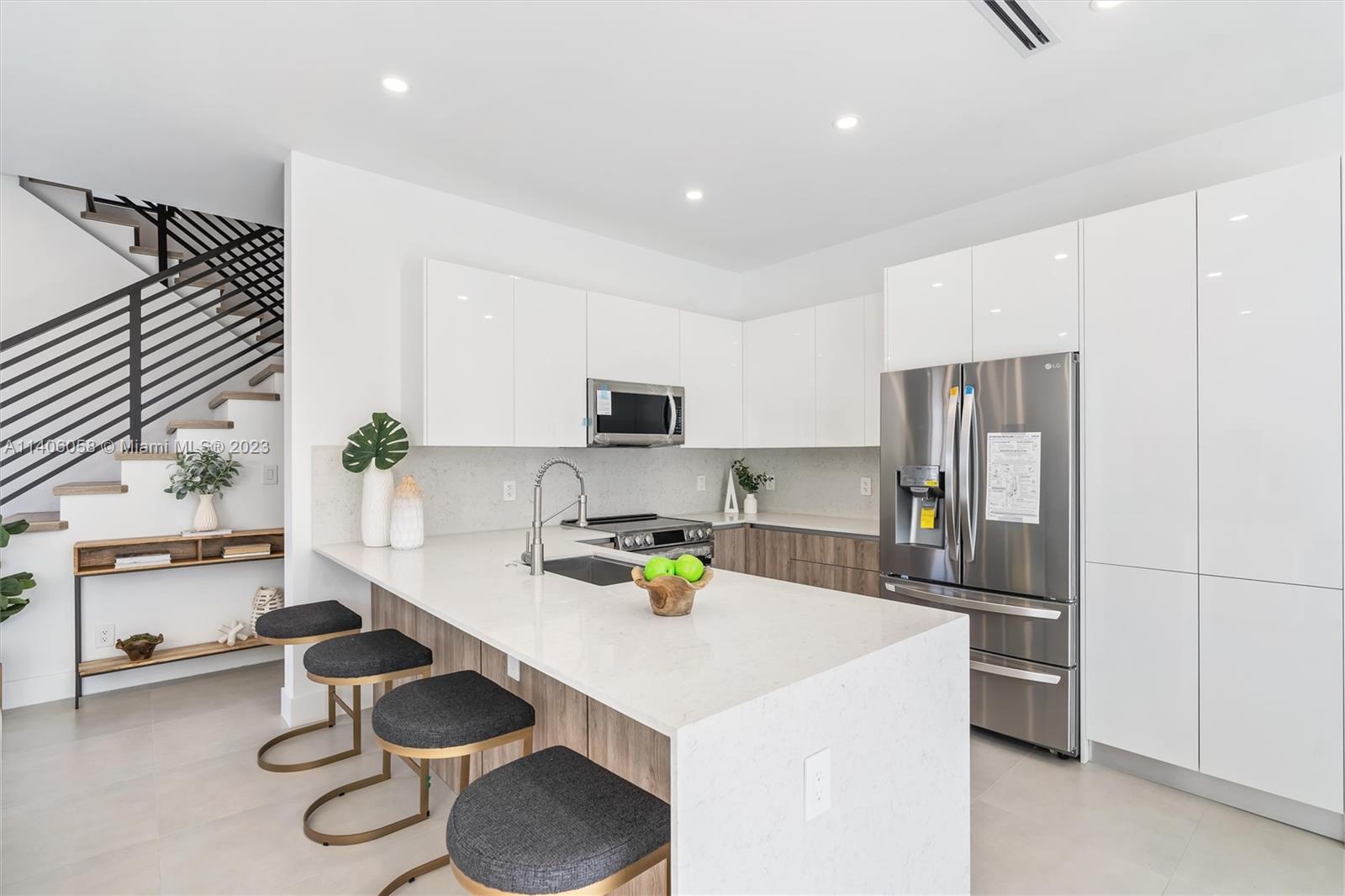 2290 Southeast 6th Street Pompano Beach, FL 33062 - Photo 3 of 22 a kitchen with a sink refrigerator and cabinets