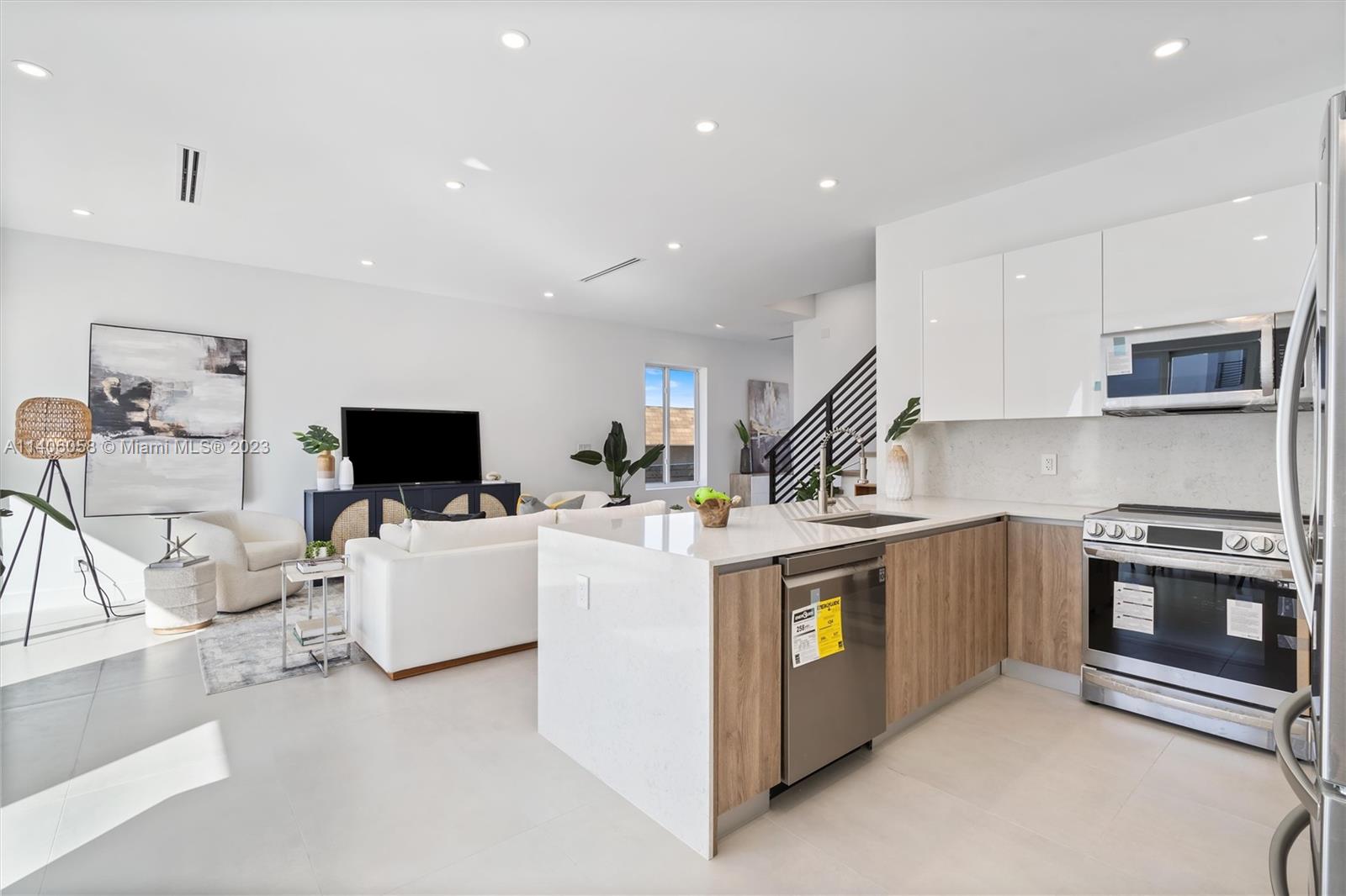 2290 Southeast 6th Street Pompano Beach, FL 33062 - Photo 5 of 22 a view of kitchen with stainless steel appliances kitchen island sink stove and refrigerator